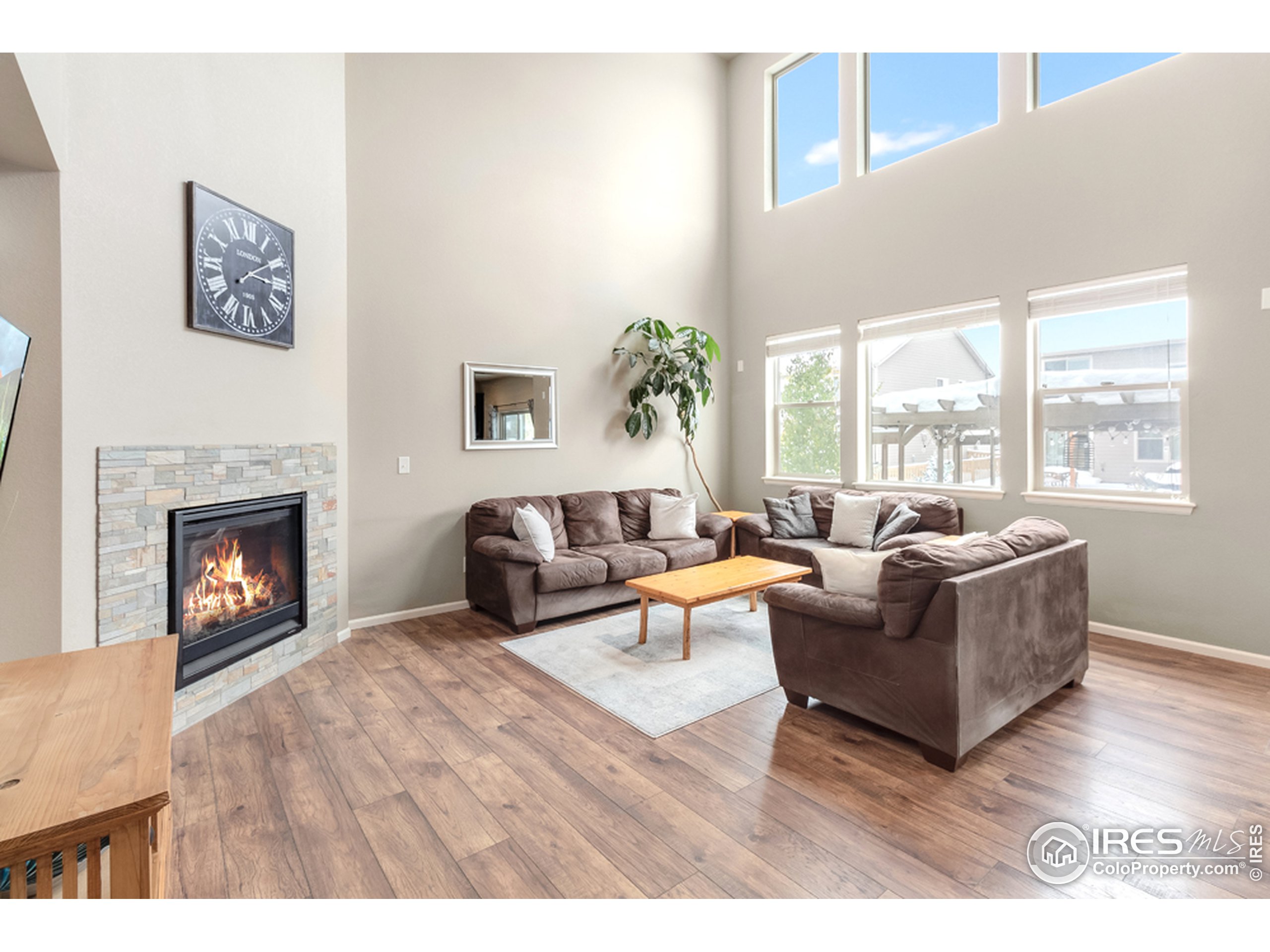 6559 Tombstone Ridge Road Timnath, CO 80547 - Photo 3 of 30 a living room with furniture and a fireplace