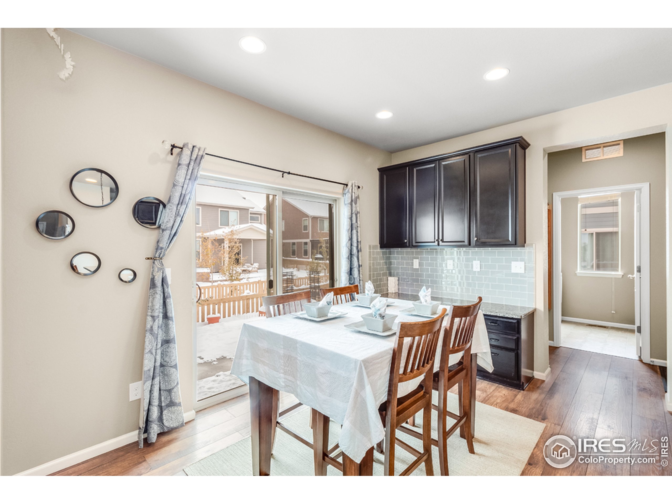 6559 Tombstone Ridge Road Timnath, CO 80547 - Photo 6 of 30 a view of a dining room with furniture and wooden floor