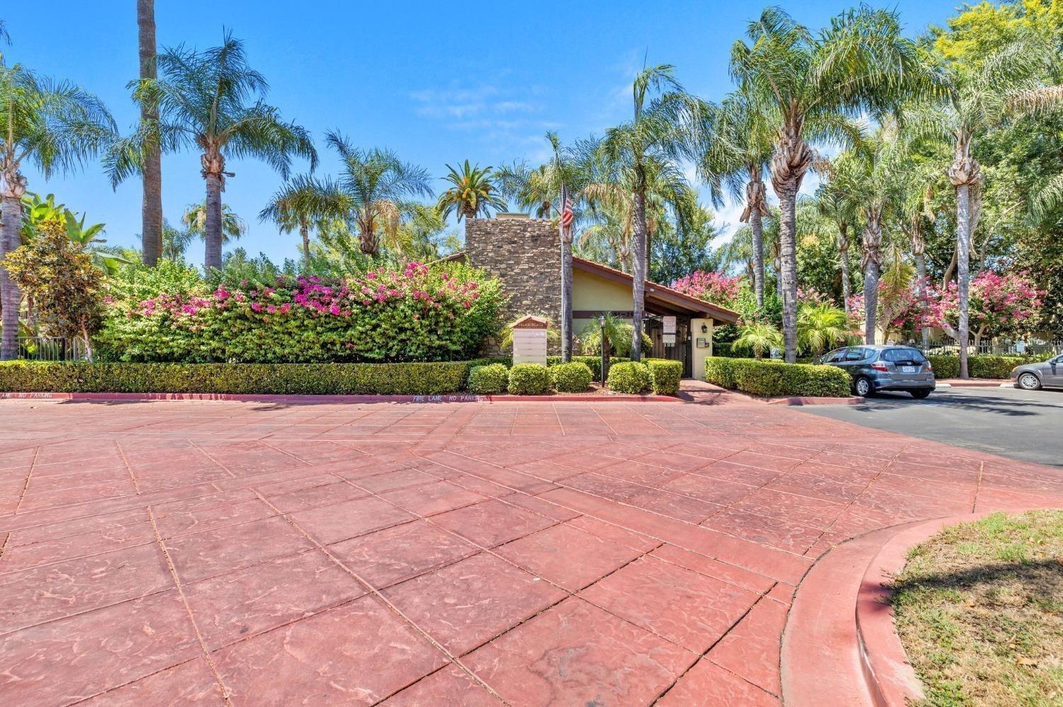 2881 Huntington Boulevard, Unit 212 Fresno, CA 93721 - Photo 1 of 17 a front view of a house with a yard and potted plants