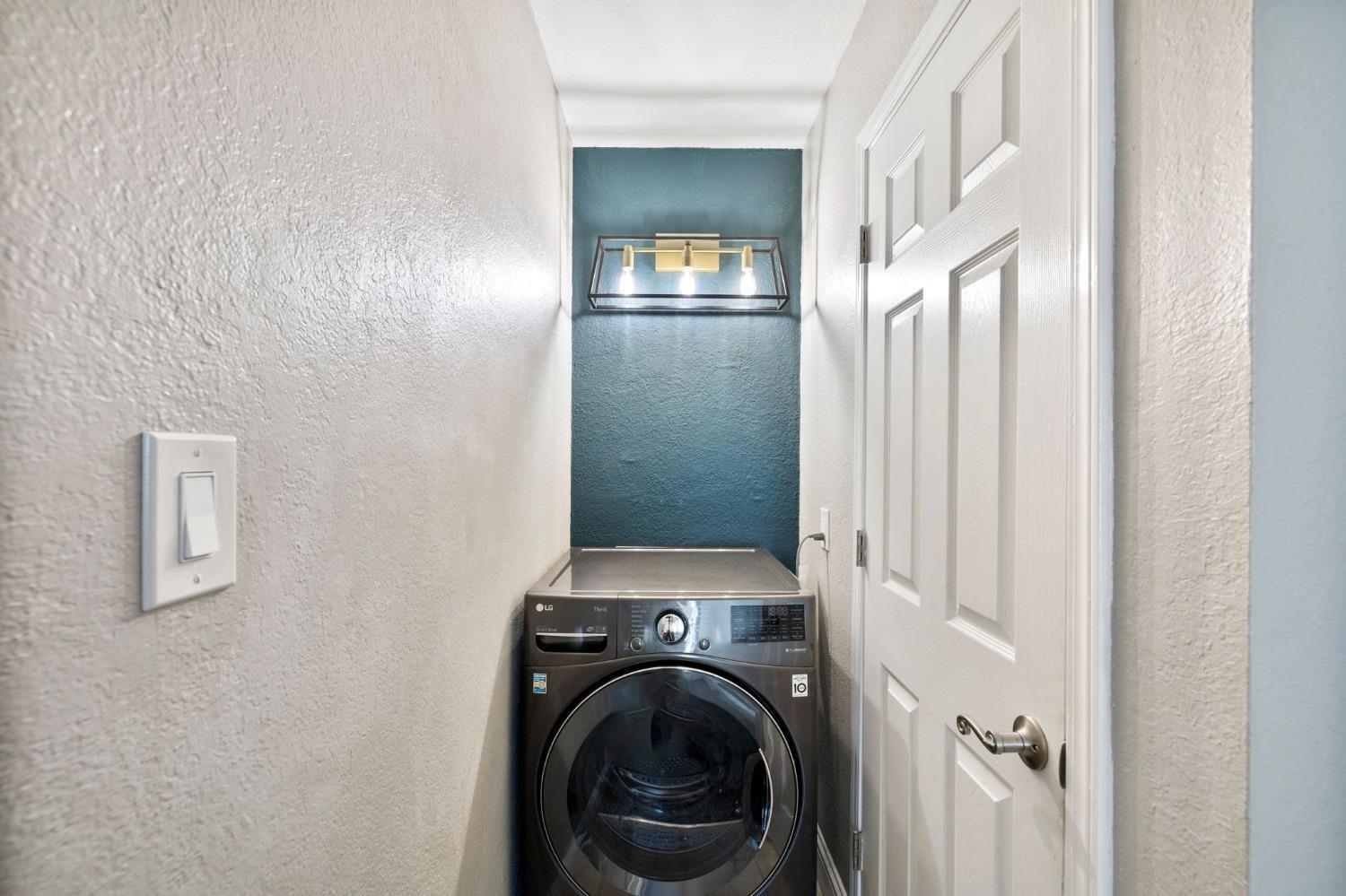 2881 Huntington Boulevard, Unit 212 Fresno, CA 93721 - Photo 14 of 17 a view of a hallway with washer and dryer