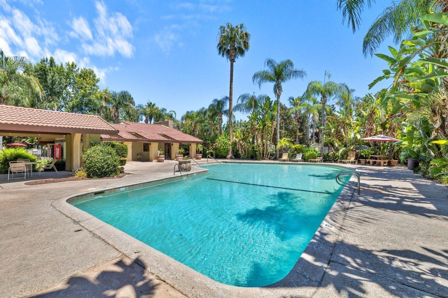 2881 Huntington Boulevard, Unit 212 Fresno, CA 93721 - Photo 15 of 17 a view of a swimming pool with a patio