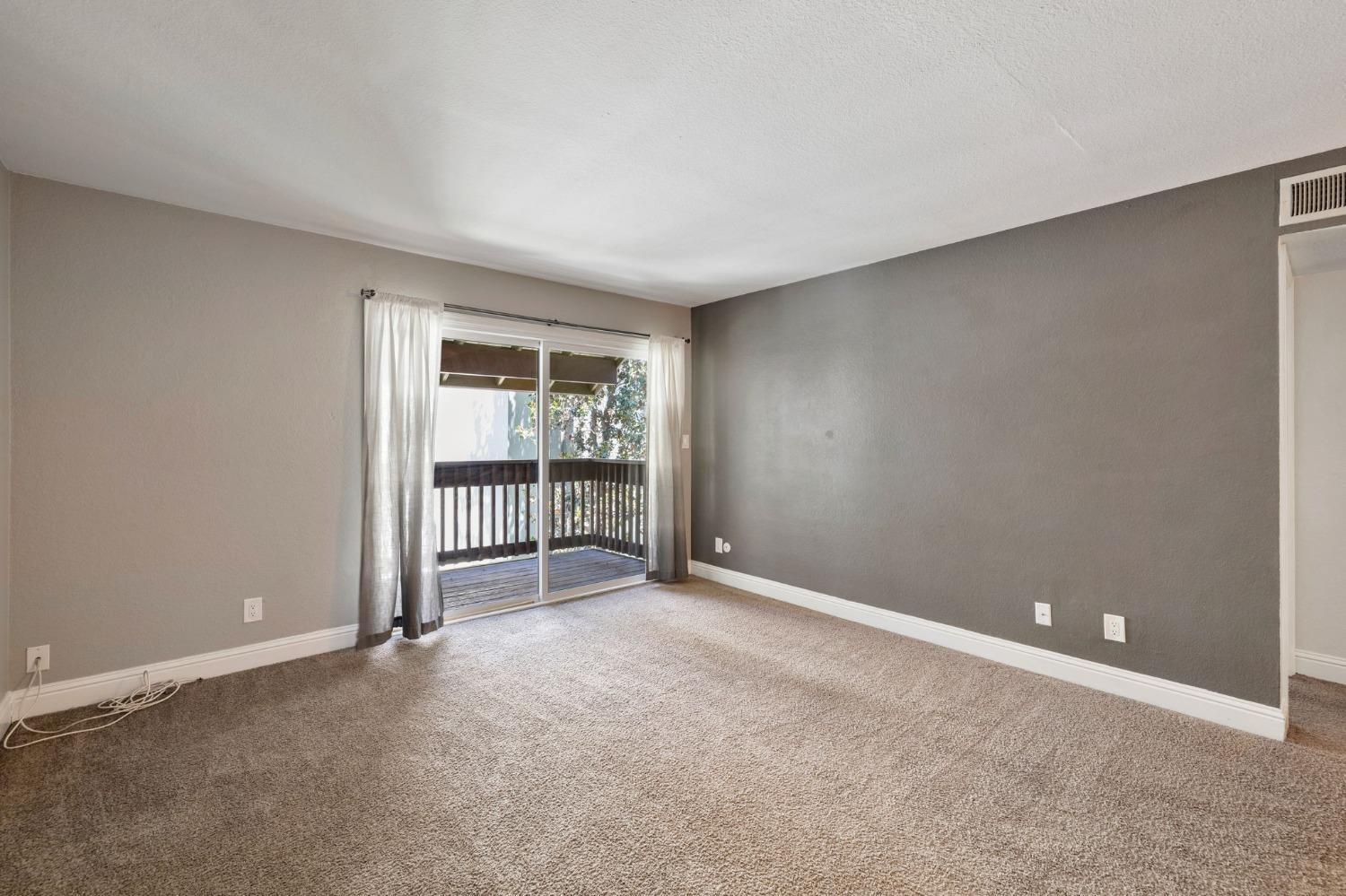 2881 Huntington Boulevard, Unit 212 Fresno, CA 93721 - Photo 5 of 17 a view of an empty room with a window