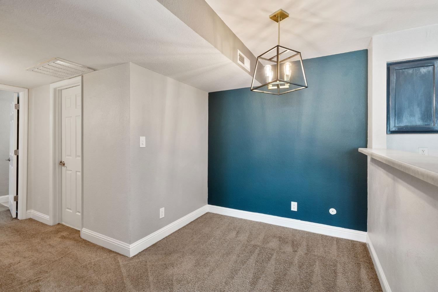 2881 Huntington Boulevard, Unit 212 Fresno, CA 93721 - Photo 10 of 17 a view of a chandelier in an empty room