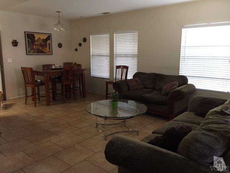 220 East 7th Street Oxnard, CA 93030 - Photo 6 of 9 a living room with furniture and a window