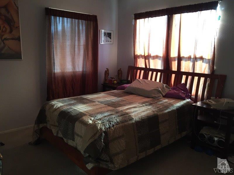 220 East 7th Street Oxnard, CA 93030 - Photo 8 of 9 a bed sitting in a bedroom next to a window
