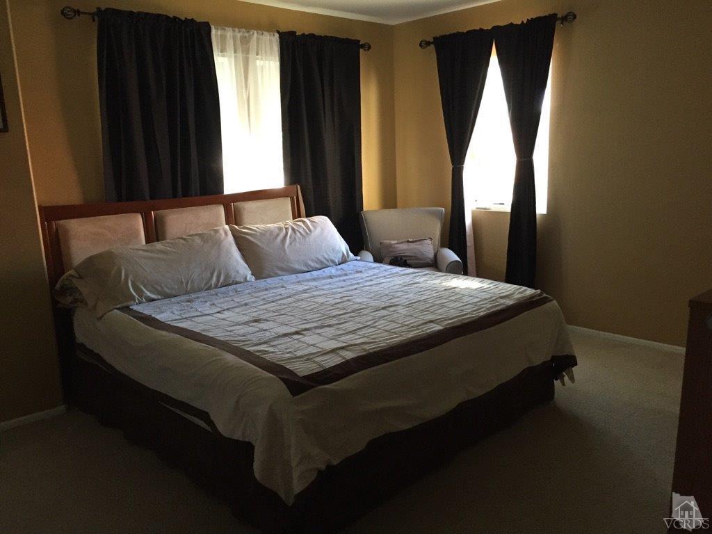 220 East 7th Street Oxnard, CA 93030 - Photo 9 of 9 a bedroom with a bed and window