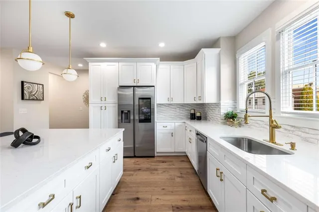 a open kitchen with stainless steel appliances granite countertop a sink and refrigerator