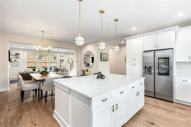 a large kitchen with a table and chairs