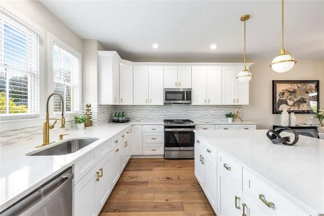 a kitchen with kitchen island white cabinets and white appliances