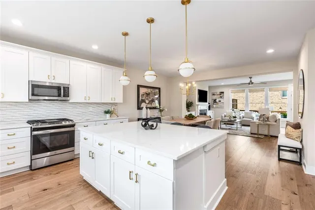 a kitchen with counter space appliances and wooden floor