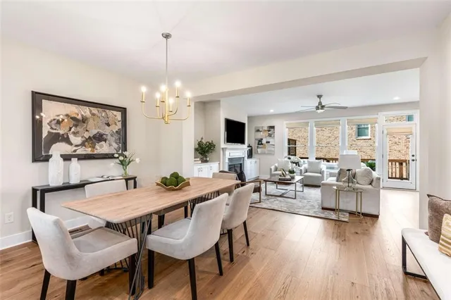 a view of a dining room with furniture wooden floor and chandelier