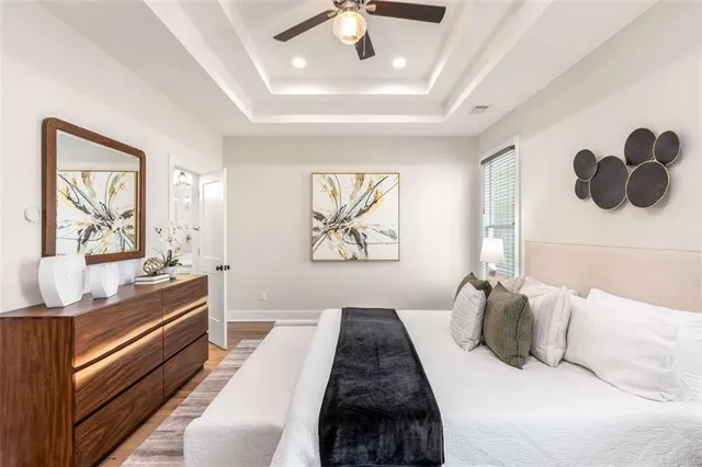 a bedroom with a bed and wooden floor