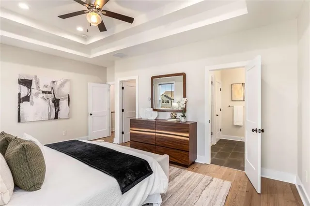 a bedroom with a large bed and a chandelier