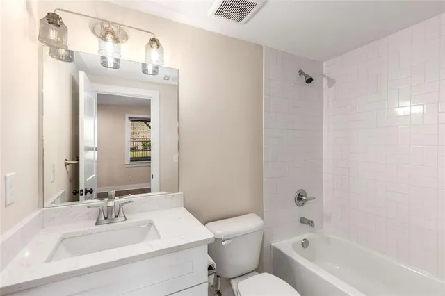 a view of a patio with couches table and chairs and potted plants