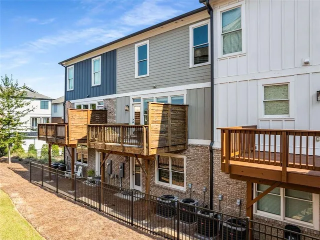 a front view of a house with a yard outdoor seating and garage