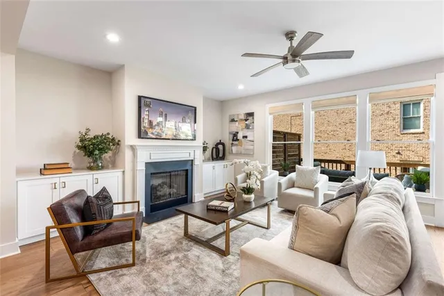 a living room with furniture a fireplace and a large window