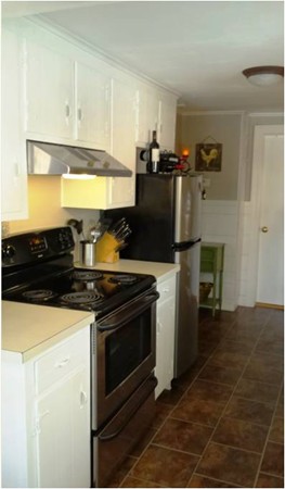 42 Boston Road Andover, MA 01810 - Photo 8 of 23 a kitchen with a stove and a refrigerator