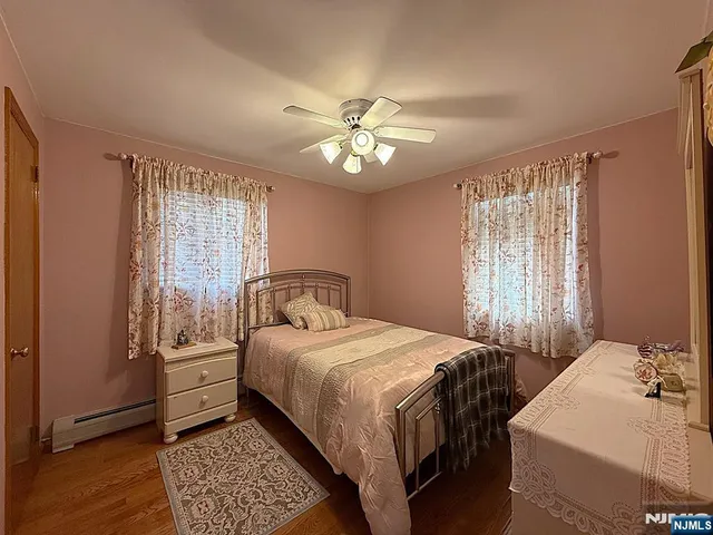 a bedroom with two beds and a window