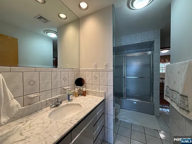 a bathroom with a toilet a sink and shower