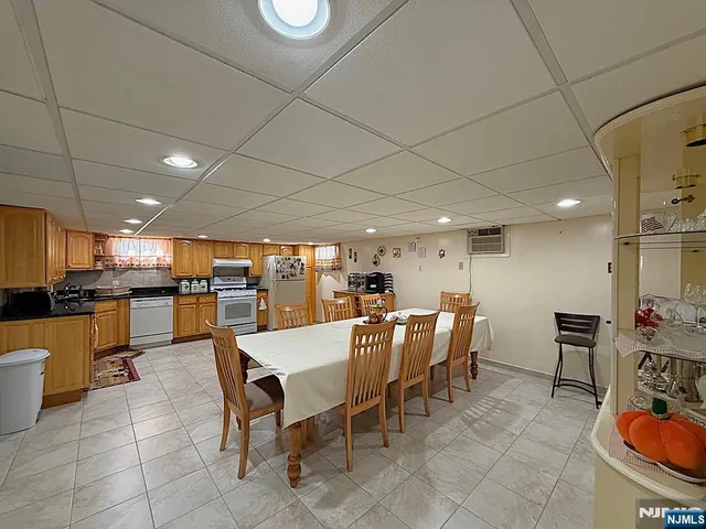 a kitchen with granite countertop a stove a sink dishwasher and a refrigerator with wooden cabinets