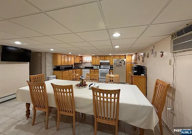 a living room with stainless steel appliances kitchen island granite countertop furniture and a view of kitchen