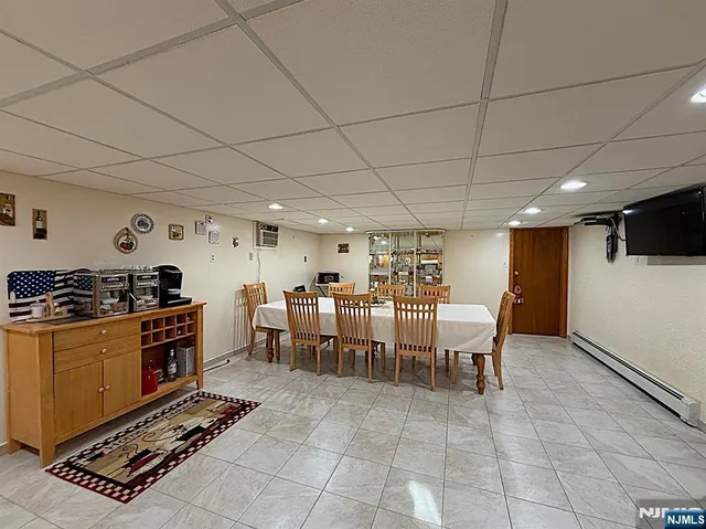 a kitchen with stainless steel appliances kitchen island granite countertop a table chairs and a refrigerator