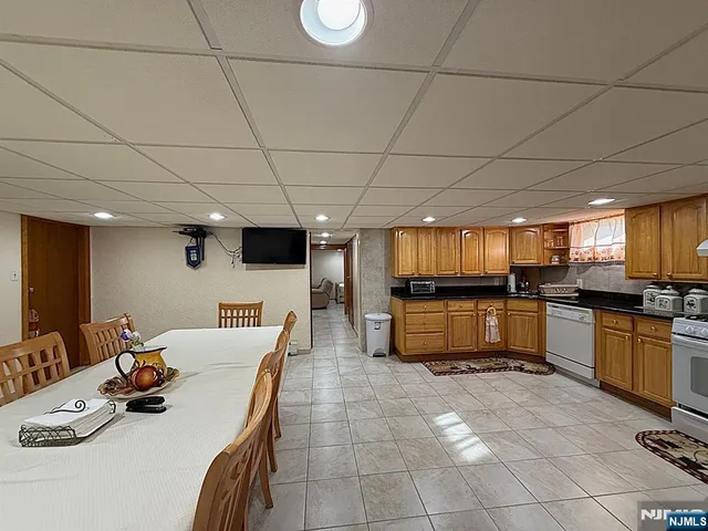 a spacious bedroom with a bed and a television