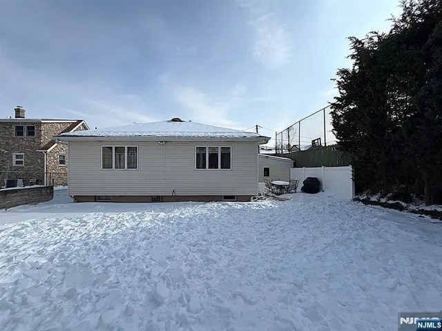 a terrace with a bench and some trees