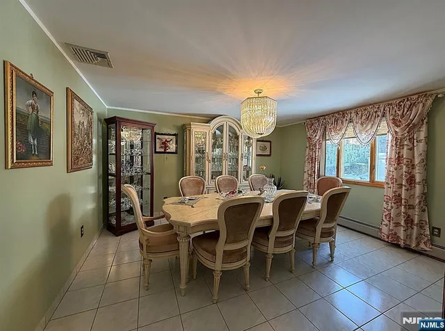 a view of a dining room with furniture and chandelier