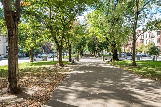 a front view of a multi story building with yard