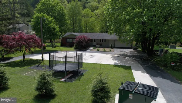 a view of backyard with outdoor seating and green space