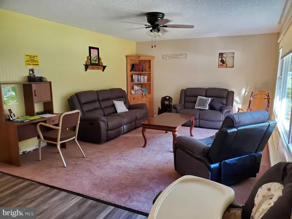 a view of a livingroom with furniture and window