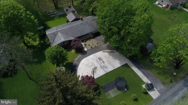 a view of a water pond with green yard