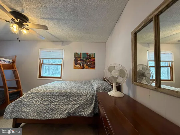 a view of a house with pool and a yard