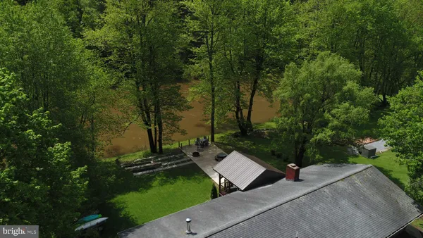 a view of a house with backyard porch and sitting area