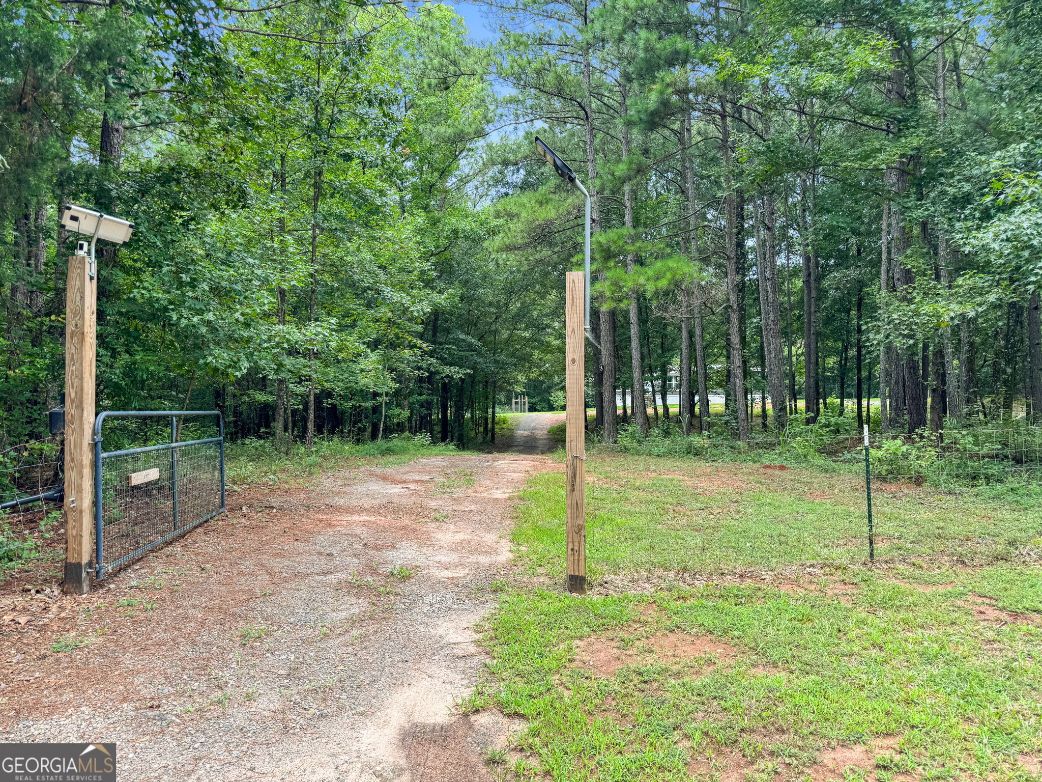 83 Old Indian Springs Road Forsyth, GA 31029 - Photo 1 of 1 a backyard of a house with lots of plants and large tree