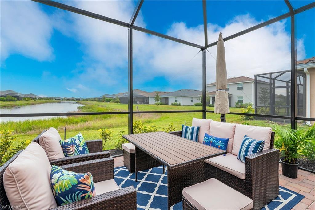 2652 Vine Avenue Naples, FL 34120 - Photo 22 of 40 a view of an outdoor sitting area with furniture and a floor to ceiling window