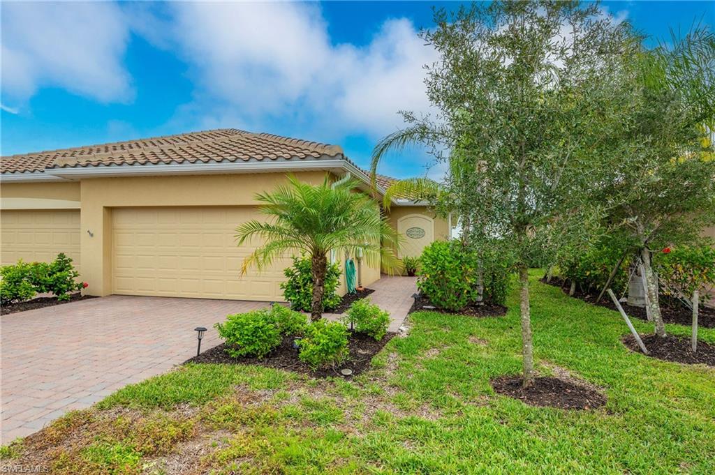 2652 Vine Avenue Naples, FL 34120 - Photo 24 of 40 a front view of a house with garden