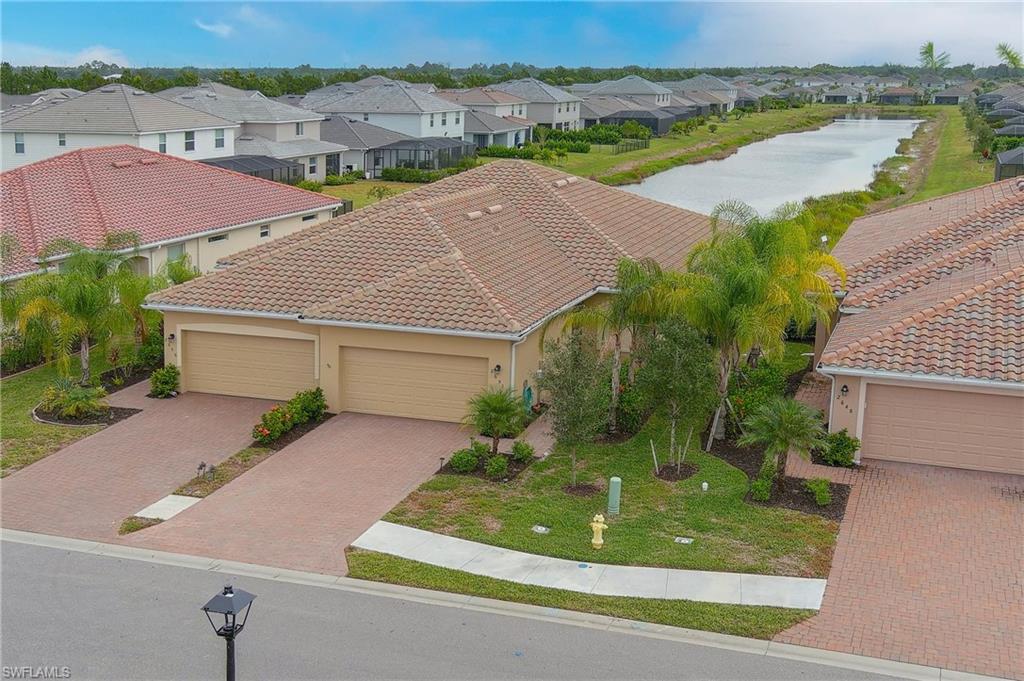 2652 Vine Avenue Naples, FL 34120 - Photo 25 of 40 an aerial view of a house with a garden and lake view