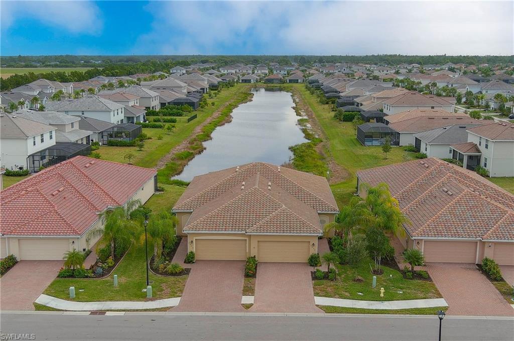 2652 Vine Avenue Naples, FL 34120 - Photo 27 of 40 an aerial view of a house with a garden and lake view