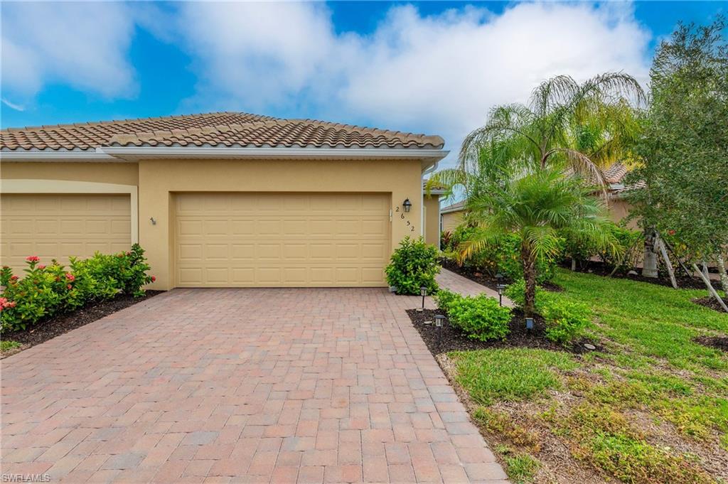 2652 Vine Avenue Naples, FL 34120 - Photo 32 of 40 a front view of a house with a yard and garage