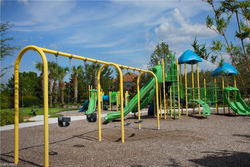 2652 Vine Avenue Naples, FL 34120 - Photo 40 of 40 a view of a swimming pool with a table and chairs