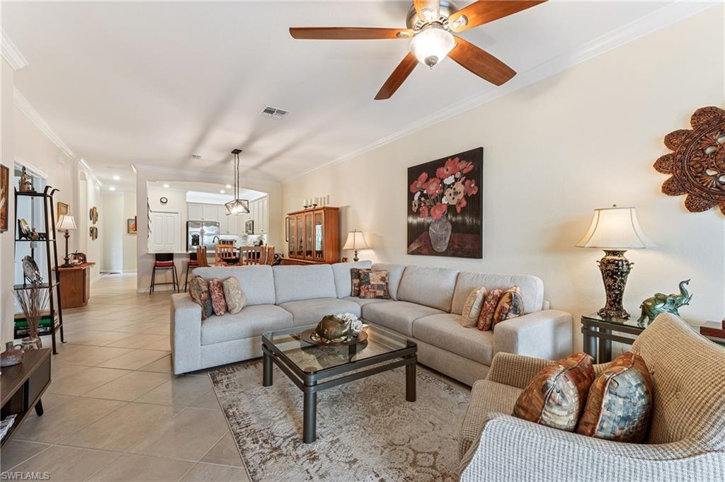 2652 Vine Avenue Naples, FL 34120 - Photo 4 of 40 a living room with furniture and a chandelier