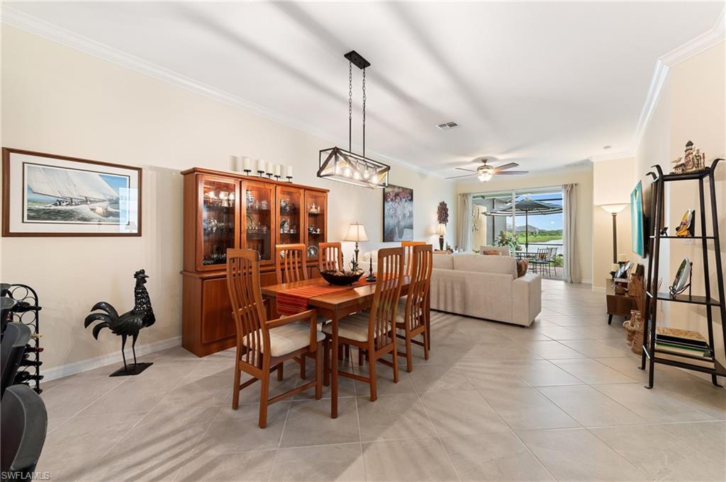 2652 Vine Avenue Naples, FL 34120 - Photo 7 of 40 a dining room with furniture and a chandelier