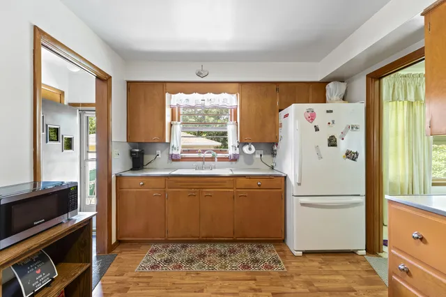a kitchen with a refrigerator and a stove top oven