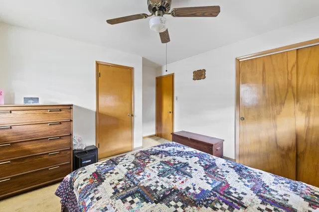 a bedroom with a bed and a dresser