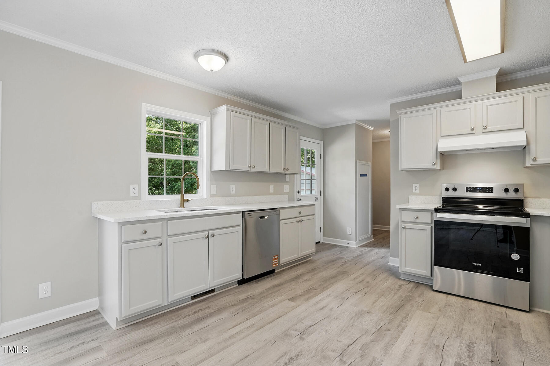 4467 Virgilina Road Roxboro, NC 27574 - Photo 8 of 30 a kitchen with granite countertop a sink cabinets stainless steel appliances and a window