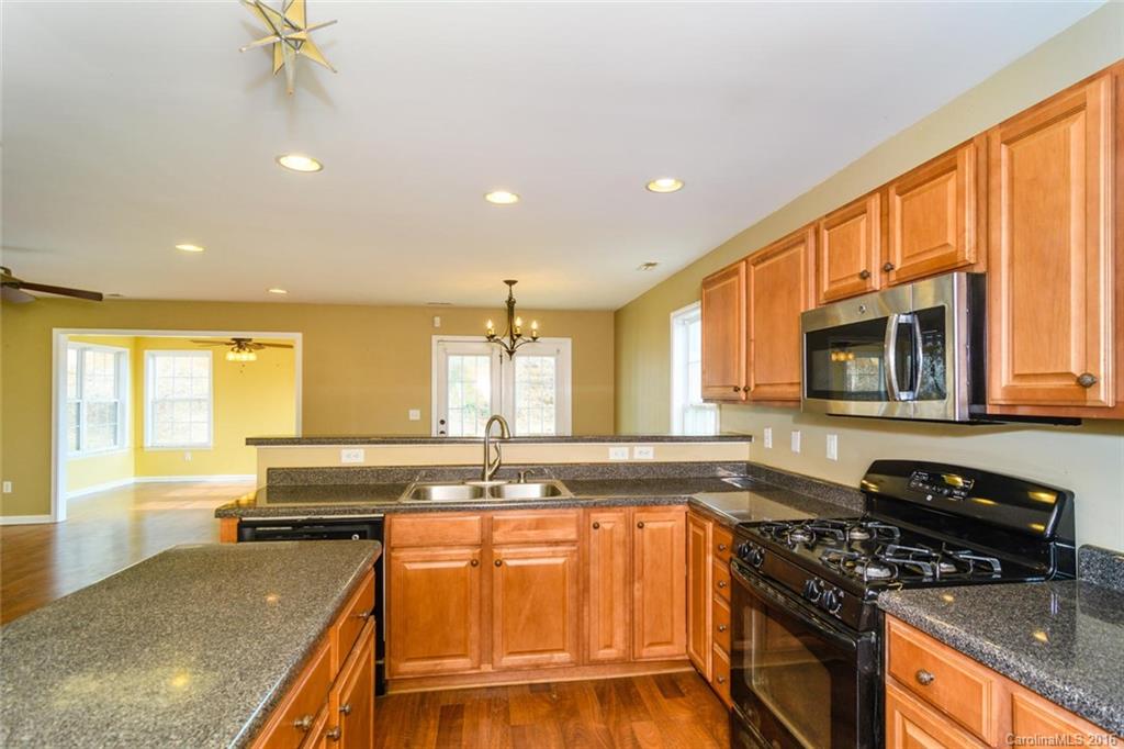 87 Yadkin Road, Unit 327 Fletcher, NC 28732 - Photo 15 of 23 a kitchen with stainless steel appliances granite countertop a sink stove and cabinets