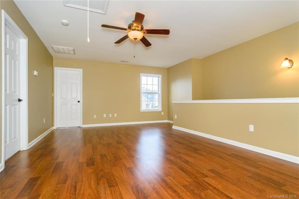 87 Yadkin Road, Unit 327 Fletcher, NC 28732 - Photo 19 of 23 a view of an empty room with window and wooden floor