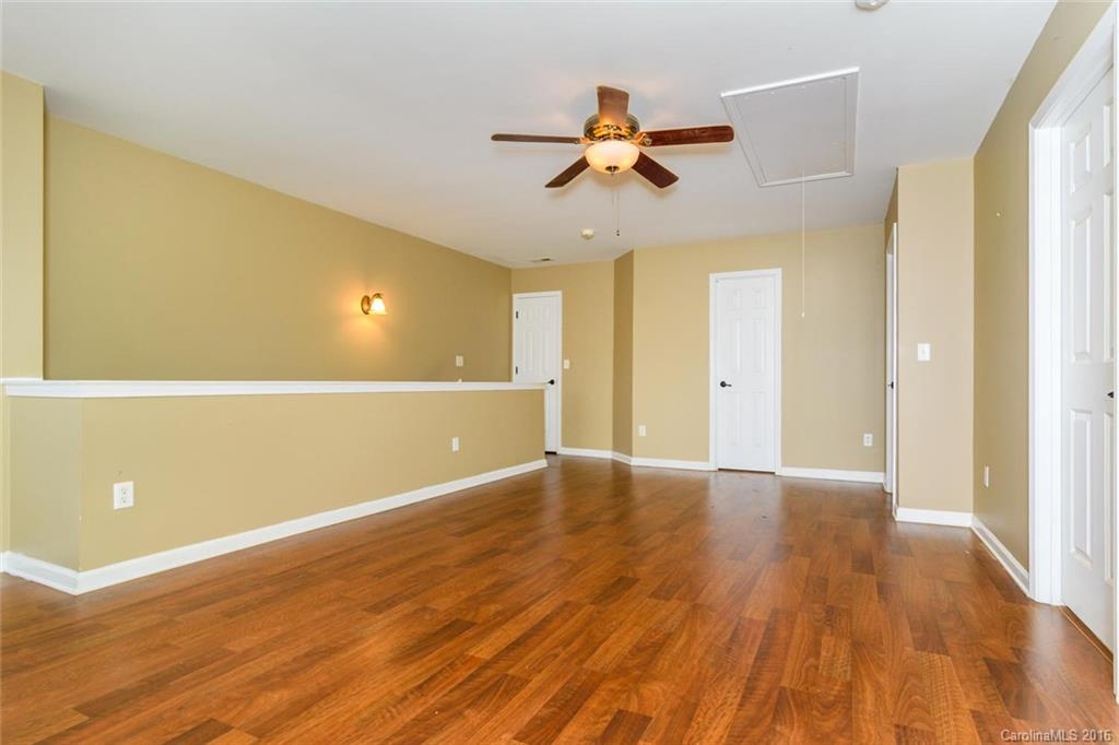 87 Yadkin Road, Unit 327 Fletcher, NC 28732 - Photo 20 of 23 a view of an empty room with wooden floor and a window